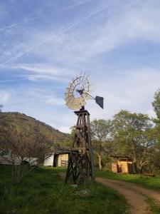 a wooden windmill sitting on the side of a dirt road at St. Anna's House in Squaw Valley