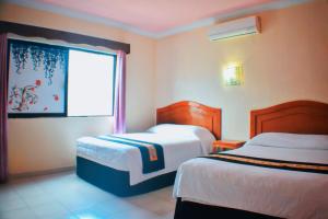 Postel nebo postele na pokoji v ubytování Hotel Hacienda Sánchez