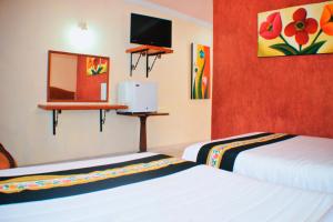 Postel nebo postele na pokoji v ubytování Hotel Hacienda Sánchez