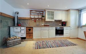 a kitchen with white cabinets and a stove at Awesome Home In Kolsassberg With Kitchen in Kolsassberg