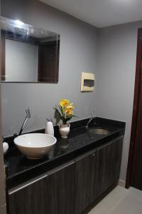 a bathroom with a sink and a mirror at Lindo Apartamento - Beira Mar de Boa Viagem in Recife +22 photos