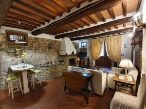 a kitchen and living room with a couch and a table at The Small Castle in Cortona