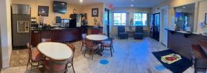 a room with a bar and some chairs and tables at Super 8 by Wyndham Chisago City in Chisago City