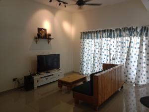 a living room with a flat screen tv and a couch at Maryam Kiara 2 in Kertih
