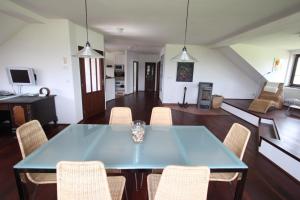 a dining room with a blue table and chairs at Luxury Apartment in Sumava Mountains in Křišťanov