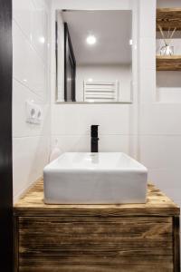 a bathroom with a white sink and a mirror at Дворівнева квартира Чорноморськ для 5 гостей - 65 in Chornomorsk