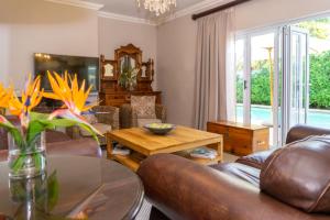 a living room with a couch and a table at Bela Rini Guesthouse in Bela-Bela