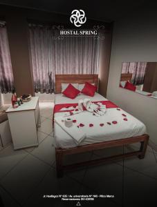 a bedroom with a bed with roses on it at Hostal Spring II in Huánuco