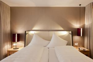 Postel nebo postele na pokoji v ubytování Hotel Walliserstube