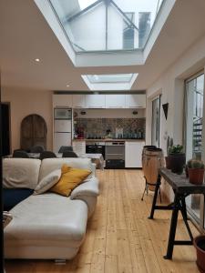 uma sala de estar com um sofá e uma cozinha em Shamshouse/Garage em Dol-de-Bretagne