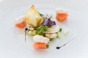 a plate of food with sushi on a white background at Atlantic Hôtel & Spa in Les Sables-d'Olonne