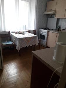 a kitchen with a table with a white table cloth at apartment Galitskaya Square in Kyiv