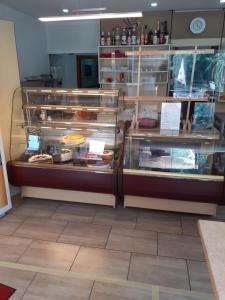 a bakery with a display case filled with different types of food at Cafe Moselterrasse in Klotten