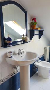 a bathroom with a sink and a mirror and a toilet at Casa de Pepa en Ribadeo in Ribadeo +27 photos