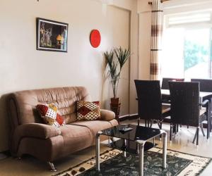 a living room with a couch and a table at Karibu BB Suites in Entebbe