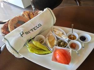 a tray of food on a table with a plate of food at To Portego tis Anatolis in Néa Péramos