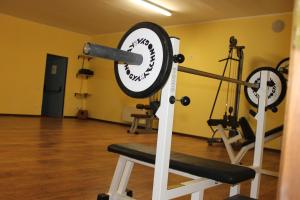 a gym with two gyms with weights at Residence La Piscina in Isola del Gran Sasso dʼItalia