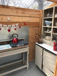 a kitchen with a tea kettle on a stove at Cefn Crib Glamping in Machynlleth