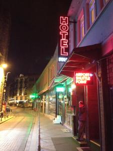 a person standing outside of a store at night at Erenler HoTeL & HosTeL in Istanbul