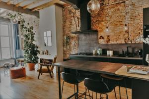 a kitchen with a counter and a brick wall at Number 9 holiday apartments in Middelburg