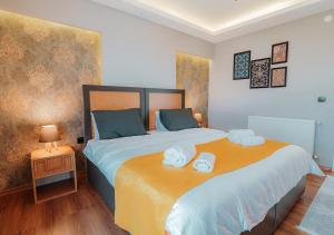 a bedroom with a large bed with towels on it at Umut Apartments in Trabzon