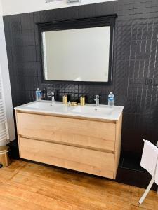 a bathroom with a sink and a large window at Chateau du Gerfaut in Azay-le-Rideau