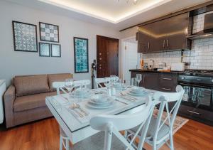 a kitchen and dining room with a table and chairs at Umut Apartments in Trabzon