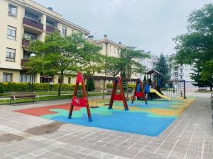 a playground with three play equipment in a park at BILBAO AEROPUERTO in Derio
