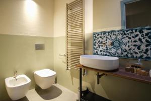 a bathroom with a sink and a toilet at Regina Bianca - Camere, Suite & Spa - Sciacca in Sciacca