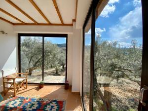 a room with a large glass door with a view at Lamin House in Sirince