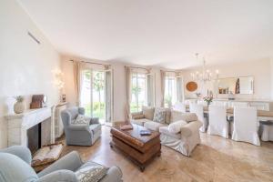 a large living room with a fireplace and a kitchen at Villa Rosa del Garda in Garda