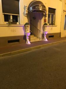 a building with purple lights on the street at Hotel Lutetia in Cannes