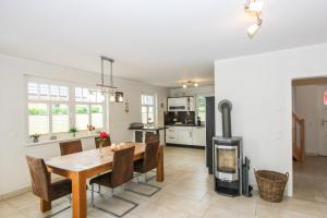 a kitchen and dining room with a table and a stove at Darß Idyll in Prerow