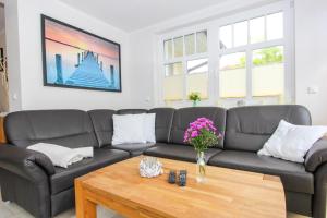 a living room with a couch and a coffee table at Darß Idyll in Prerow