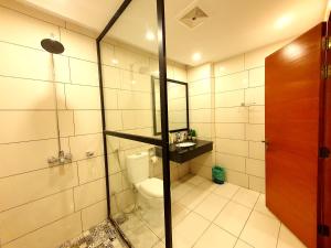 a bathroom with a toilet and a glass shower at Executive Apartments In Bahria Heights in Rawalpindi
