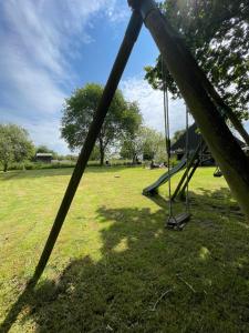 a swing set in a grassy field at Entre terre et mer in Combrit