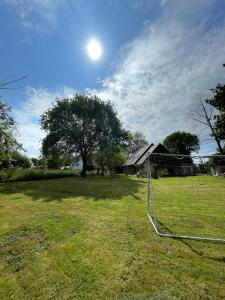 a soccer net in a field with a tree at Entre terre et mer in Combrit