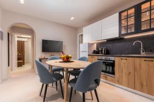 a kitchen with a table and chairs in a kitchen at Rapanos Apartments in Paleokastritsa
