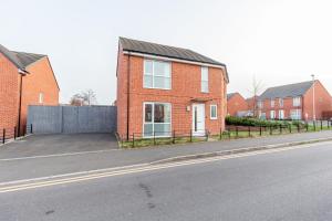 a red brick house on the side of a street at Liberty House - Perfect for Contractors - 2 Off-Road Parking Spaces in Wolverhampton