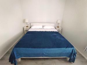 a bedroom with a bed with a blue blanket on it at Feel Dugi Otok - Apartment Sofia in Luka