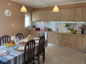 a kitchen with a table and chairs and a dining room at Bonaventura - Countryside Villa near Split with Private Pool in Donja Mala