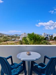 a table and two chairs on a balcony with a table at Kalamuria Studios in Plaka