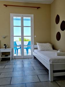 a bedroom with a bed and a view of the ocean at Kalamuria Studios in Plaka