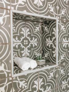 a bathroom with a shelf with towels on a wall at Quinta Costa da Estrela in Gouveia