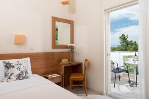 Ένα ή περισσότερα κρεβάτια σε δωμάτιο στο Louloudis Boutique Hotel