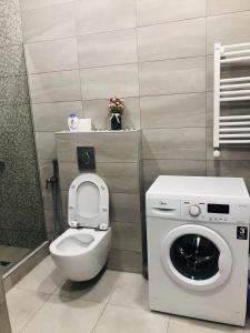 een badkamer met een toilet en een wasmachine bij Wellconect in Koetaisi