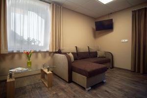 a living room with a couch and a table at Bodzaház Apartman in Tarján