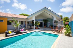 a villa with a swimming pool and a house at Villa Curazon met privézwembad vlakbij het strand! in Jan Thiel