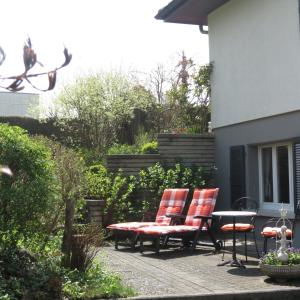 two chairs and a table on a patio at B&B Andrey in Marly-le-Grand