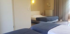 Ein Bett oder Betten in einem Zimmer der Unterkunft Hotel Westendia